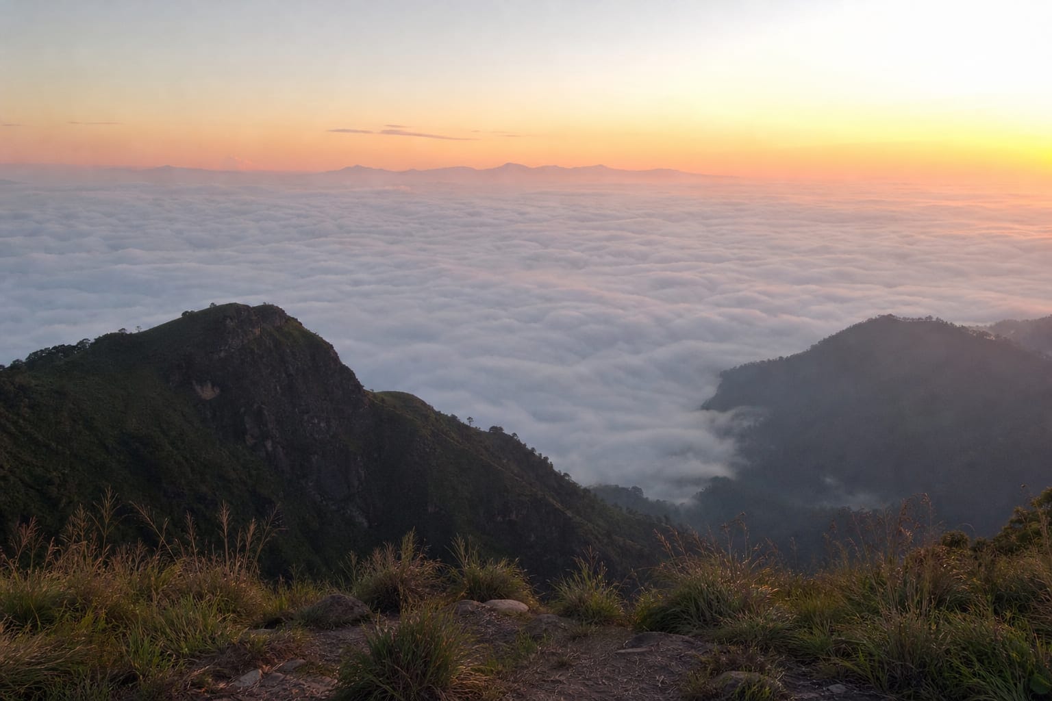 Cloud filling the valley seen from the flat summit of Ella Rock at sunrise