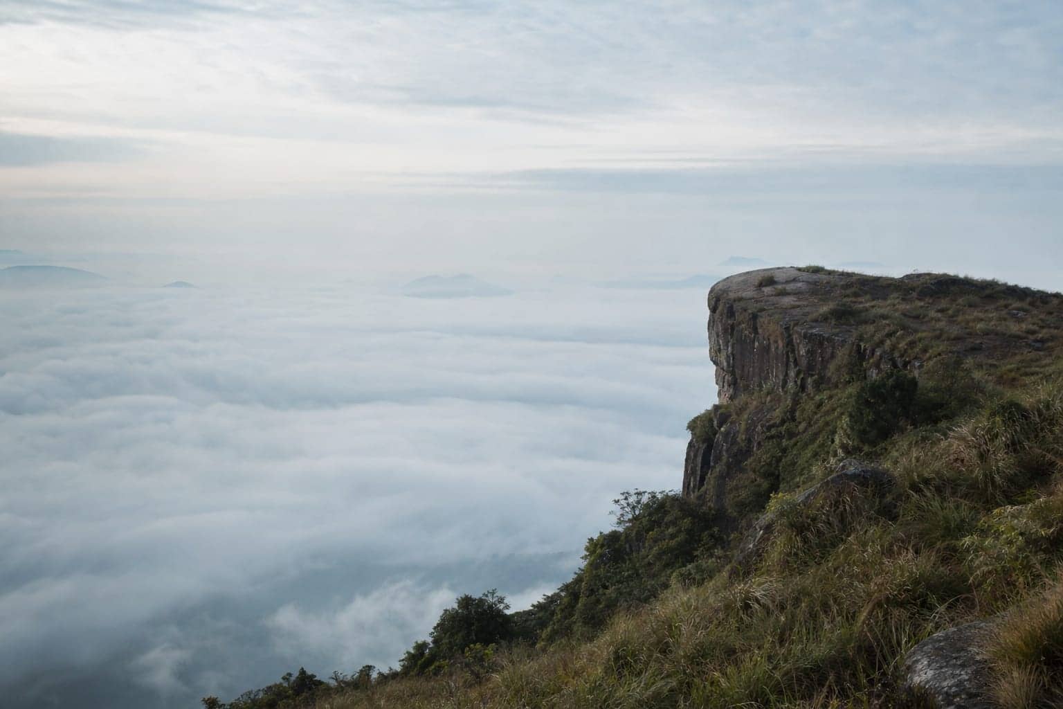Cloud filling the valley below a flat rock summit in the Sri Lankan hill country