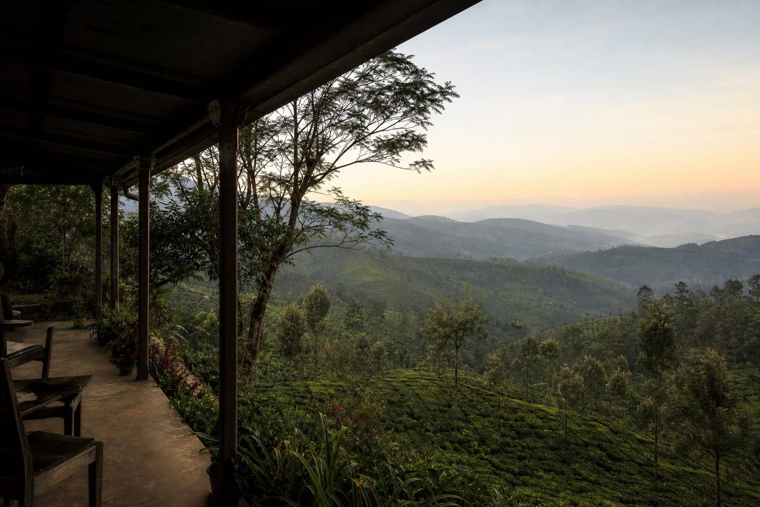 A verandah looking over tea estate slopes at dawn above Haputale, Sri Lanka